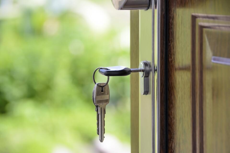 A key left in the lock of a front door
