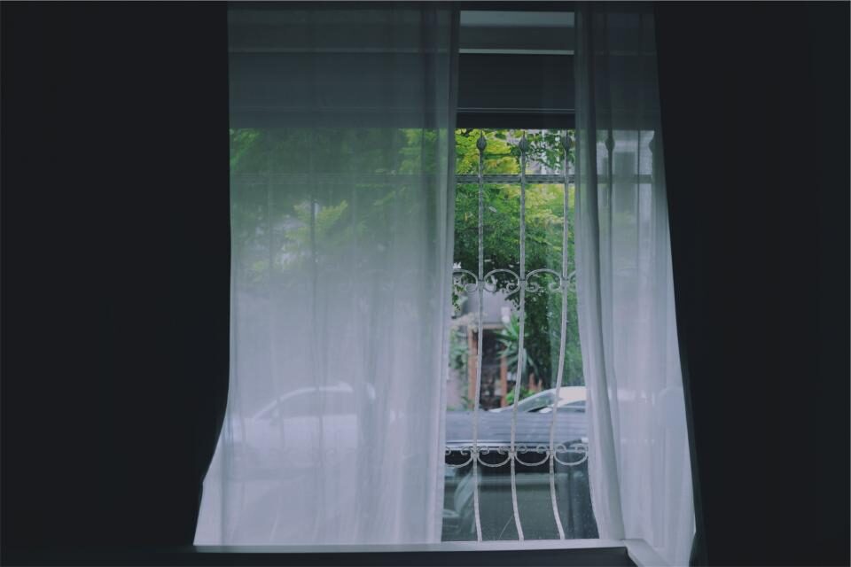 A window with the curtain drawn across it