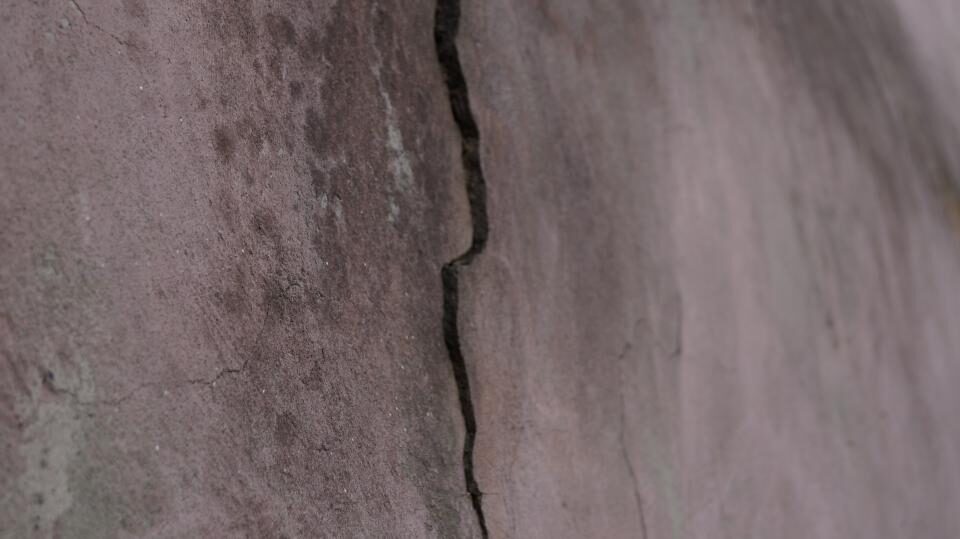 A long crack running through a plastered wall