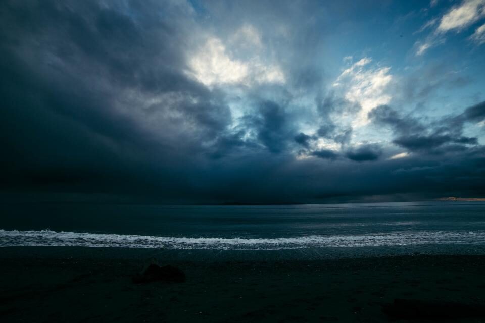 Storm clouds gathering over a grey sea