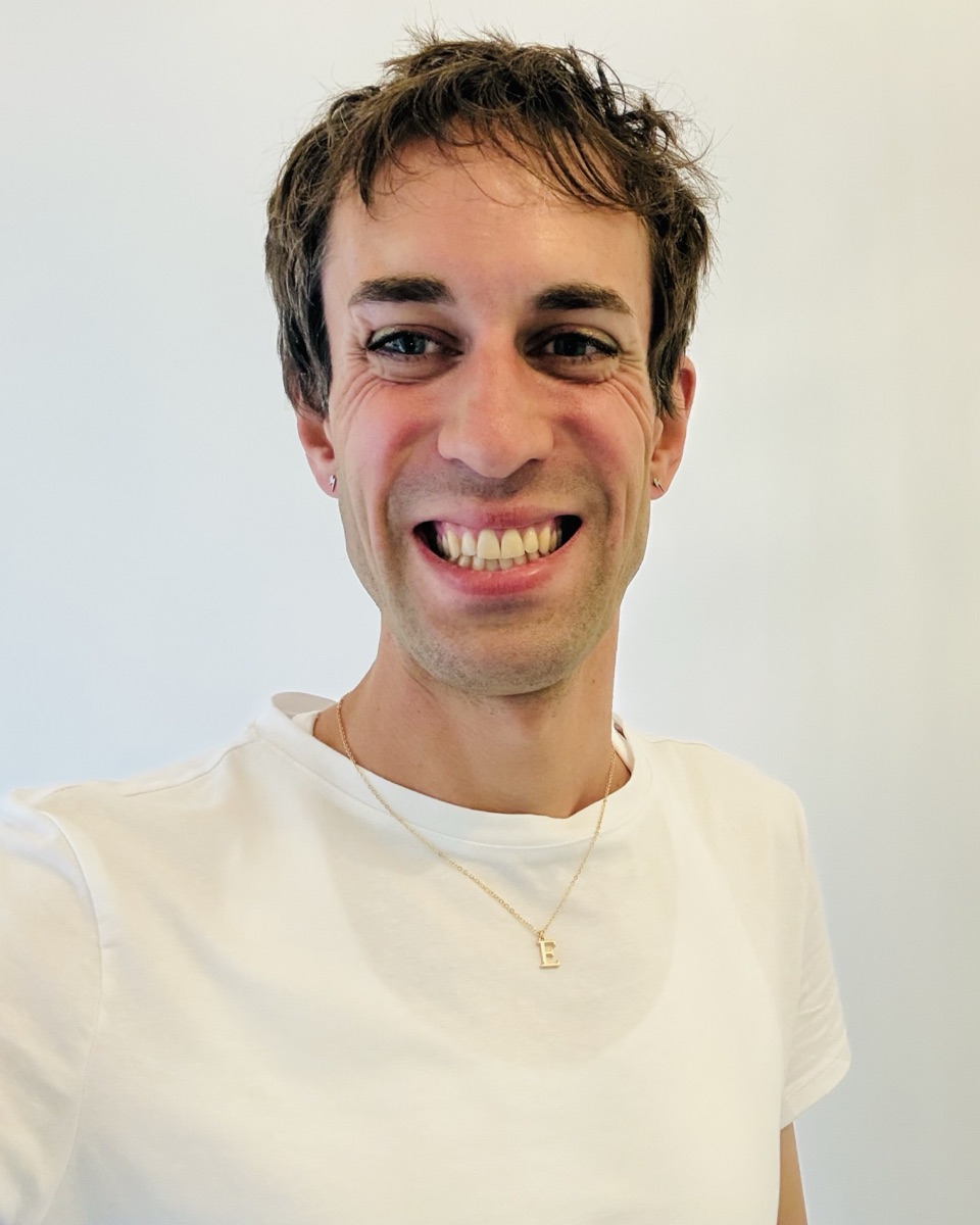 Eve Anderson, founder of Lighthouse Software, smiling in a white t-shirt