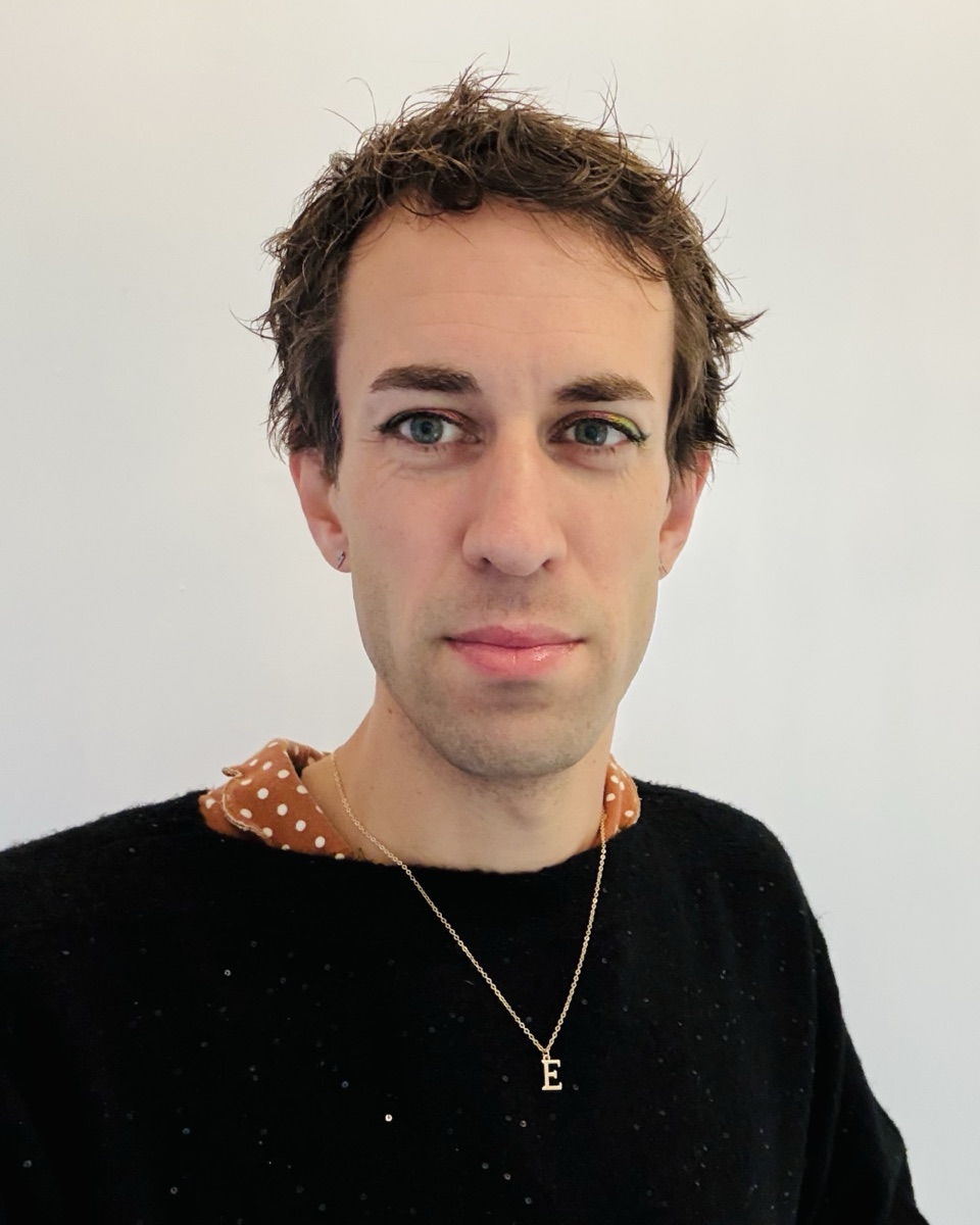 Eve Anderson, founder of Lighthouse Software, looking at the camera in a black jumper with rainbow eyeliner